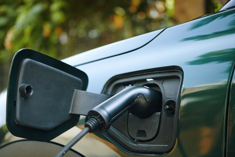 EV charger charging a green car